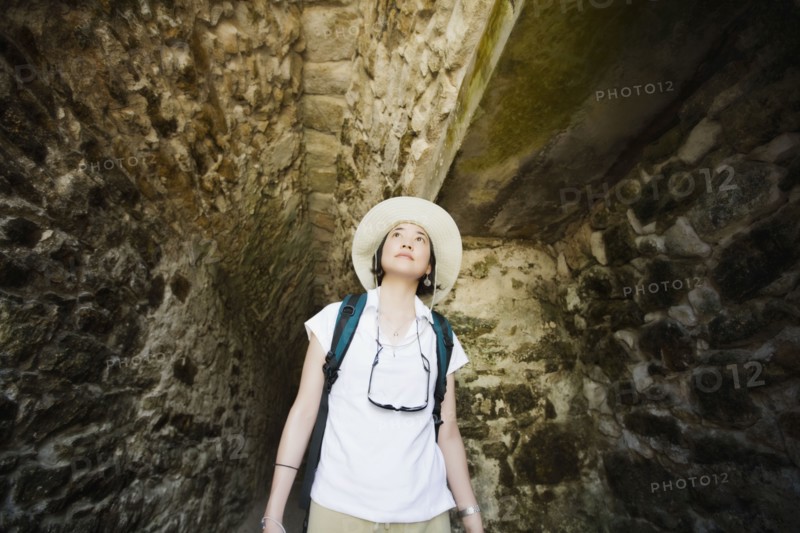 Asian woman walking in tunnel
