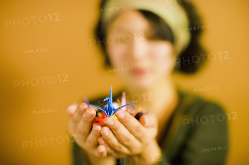 Japanese woman holding origami bird