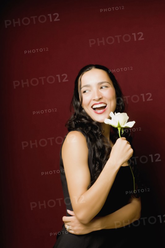 Hispanic woman posing with white rose