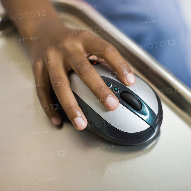African girl's hand on computer mouse