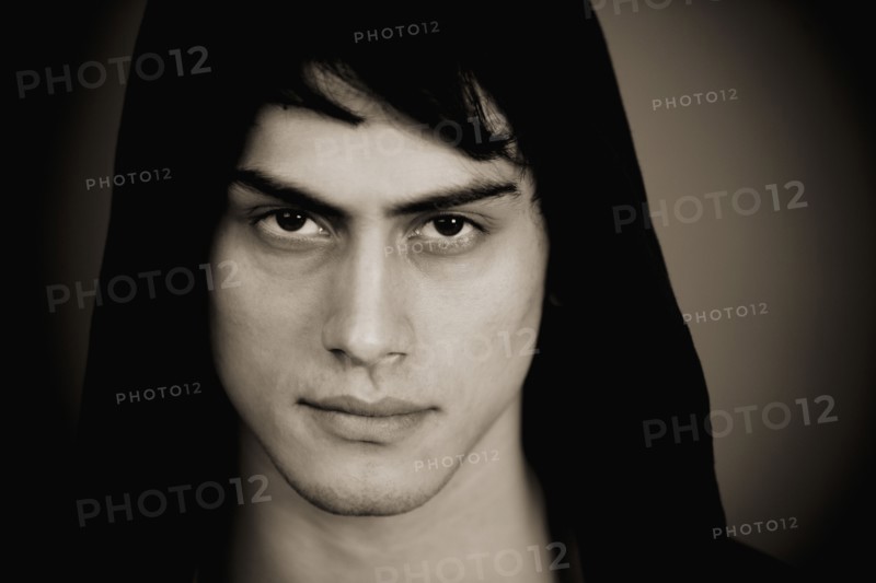 Serious mixed race man in hooded jacket