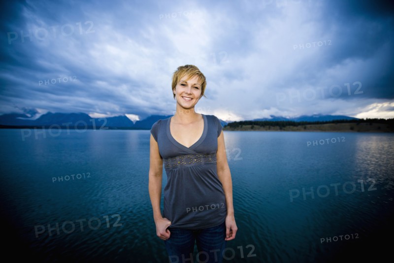 Caucasian woman standing near lake