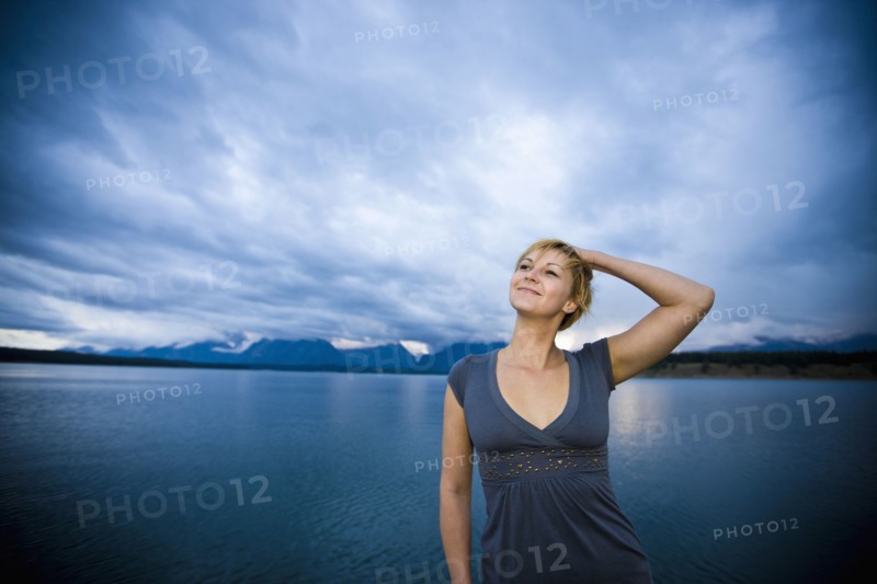 Caucasian woman standing near lake