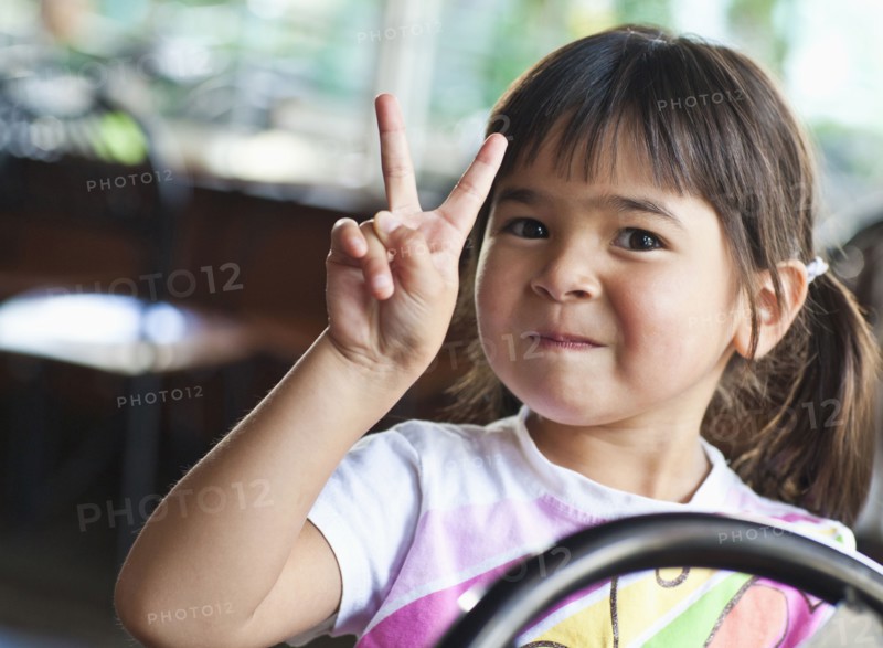 Asian girl making peace sign