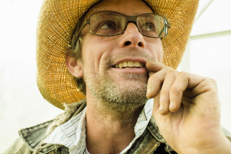 Caucasian farmer wearing straw hat outdoors