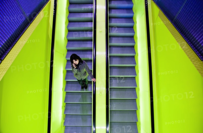Japanese woman riding escalator