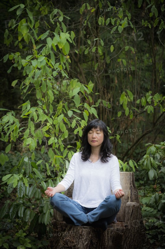 Japanese woman meditating in garden