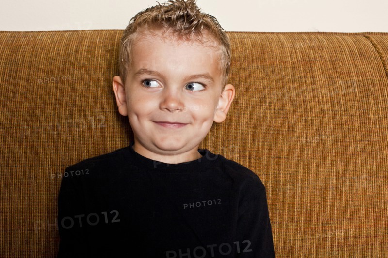 Caucasian boy sitting on sofa