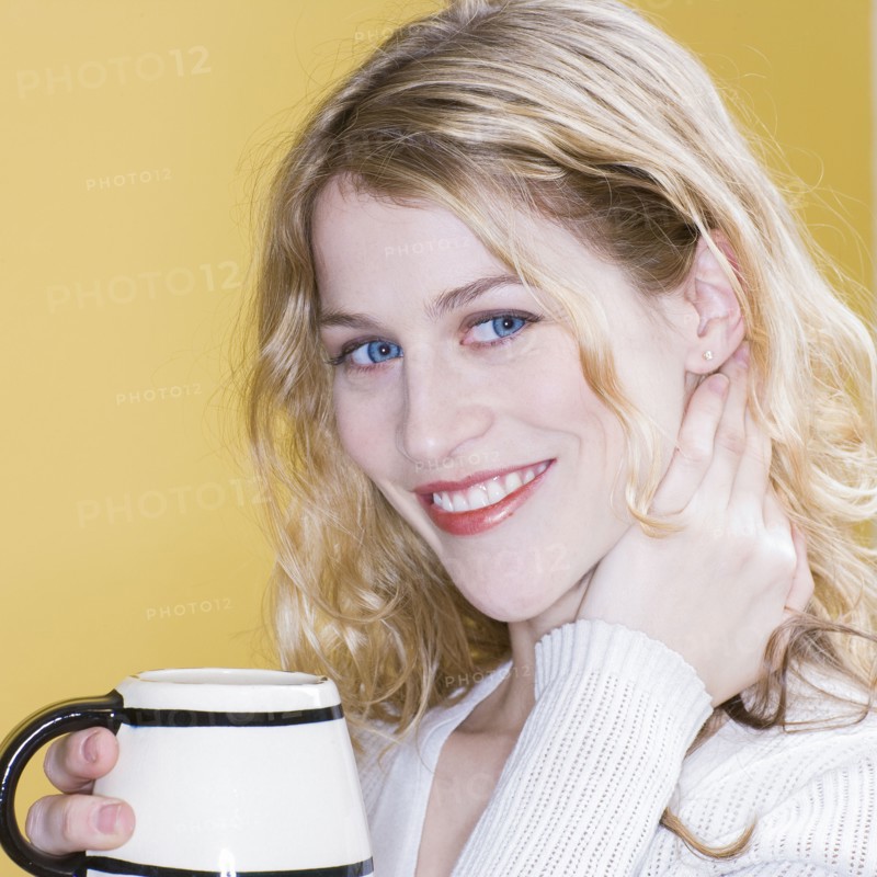 Smiling woman drinking cup of coffee