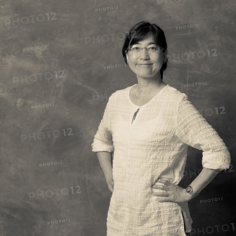 Japanese woman smiling with hands on hips