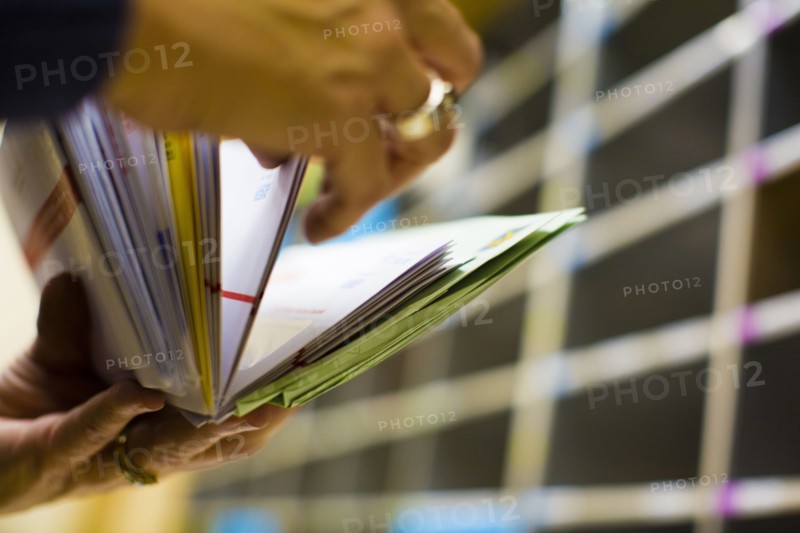 Hands flipping through mail