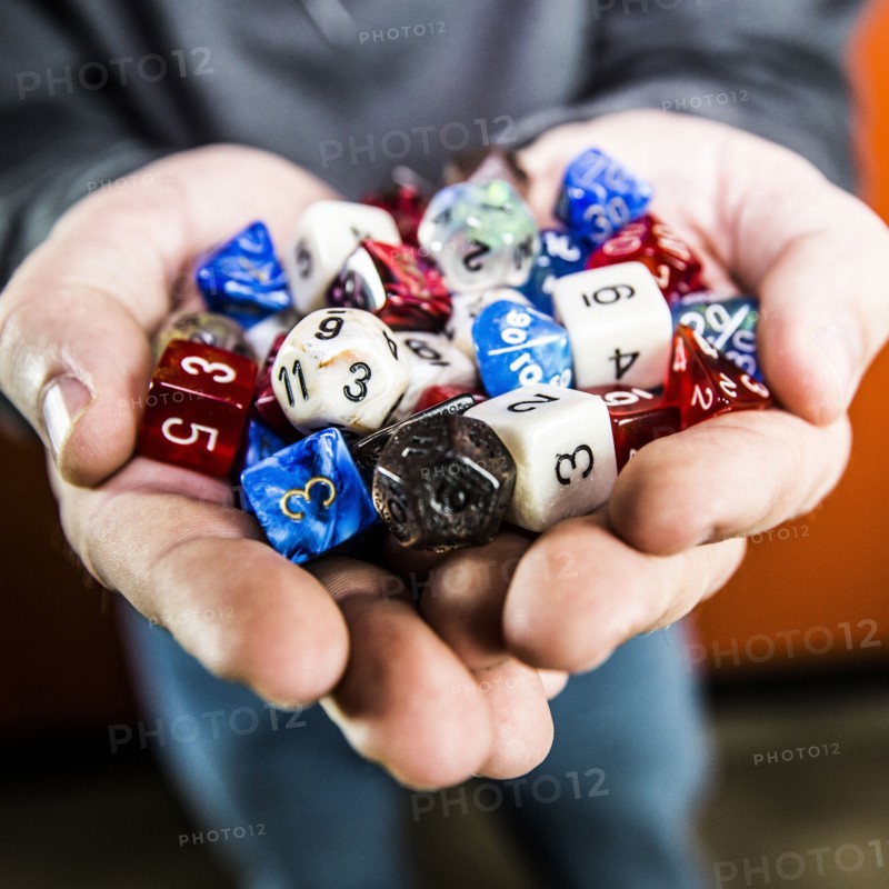 Hands holding variety of dice