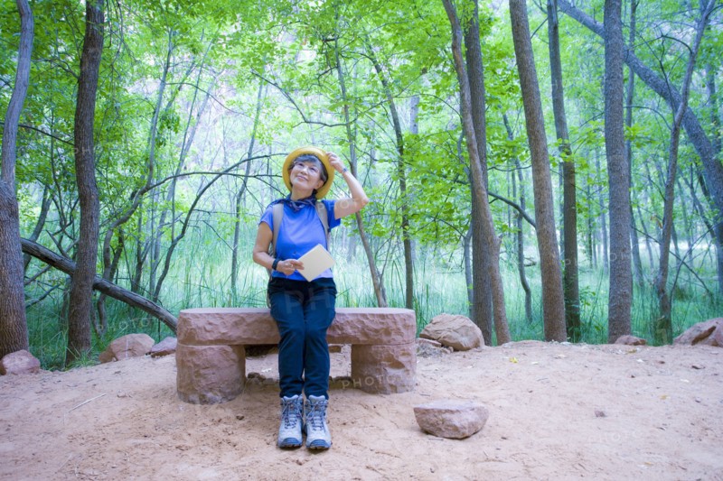 Japanese woman sitting on bench at park