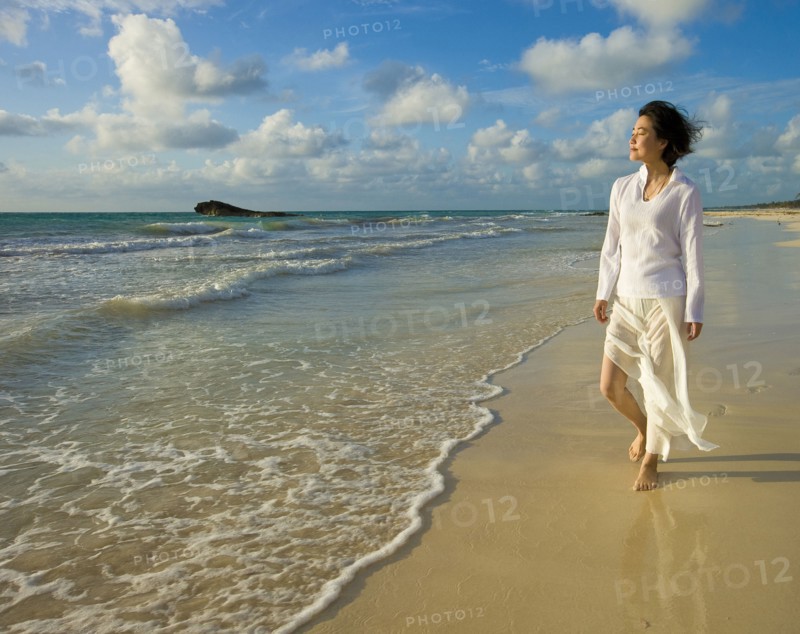 Japanese woman walking on beach