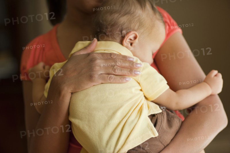 Mother holding sleeping child