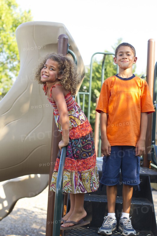 Mixed race children playing on playground