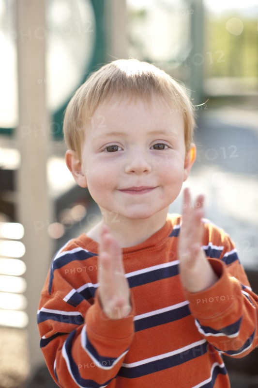 Caucasian boy clapping his hands