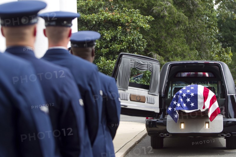 Soldiers watching casket at military funeral