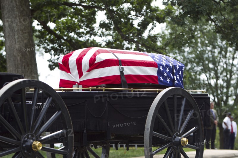 American flag over casket at military funeral