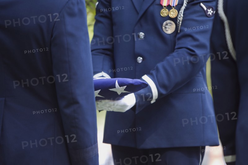 Soldiers folding flag at military funeral