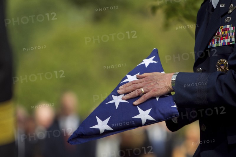 Soldier folding flag at military funeral