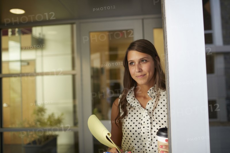 Mixed race businesswoman standing in office