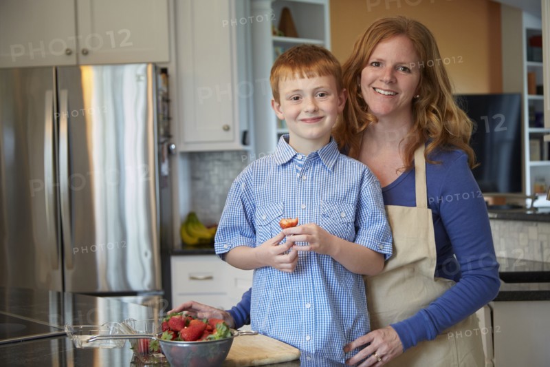 Caucasian mother and son cooking in kitchen