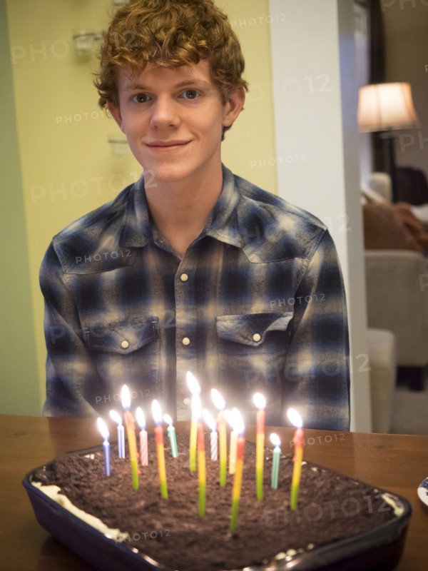 Caucasian boy smiling with birthday cake