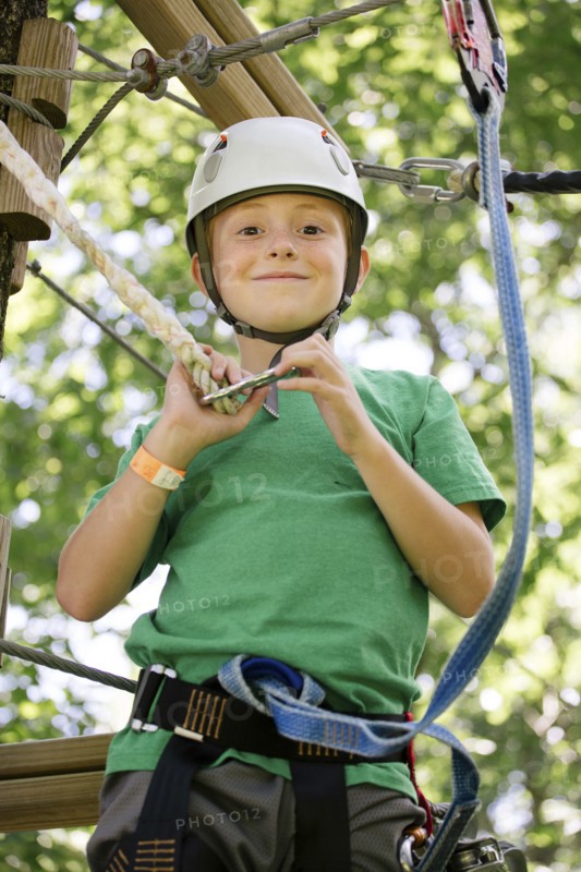 Caucasian boy hooking harness to line
