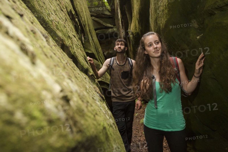 Caucasian couple exploring cave