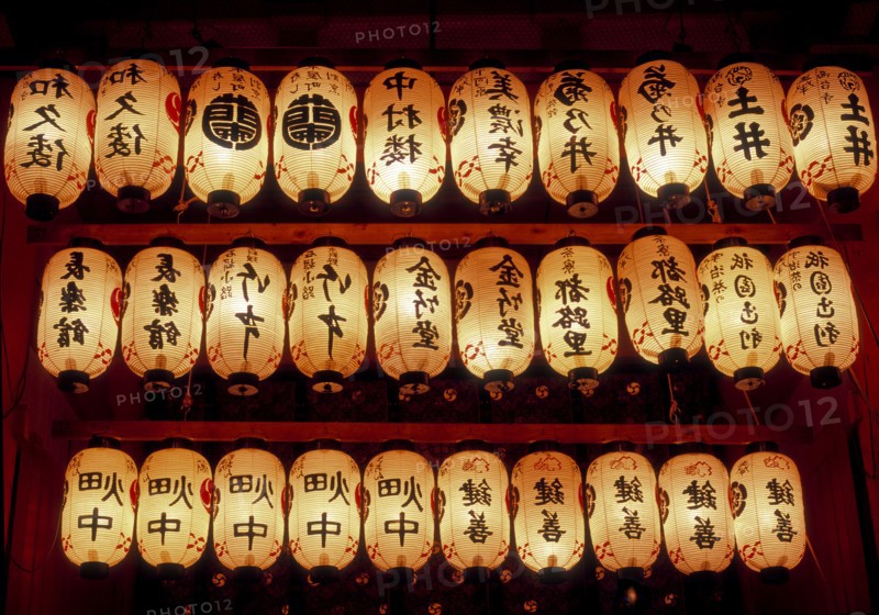 Rows of illuminated prayer lanterns at night