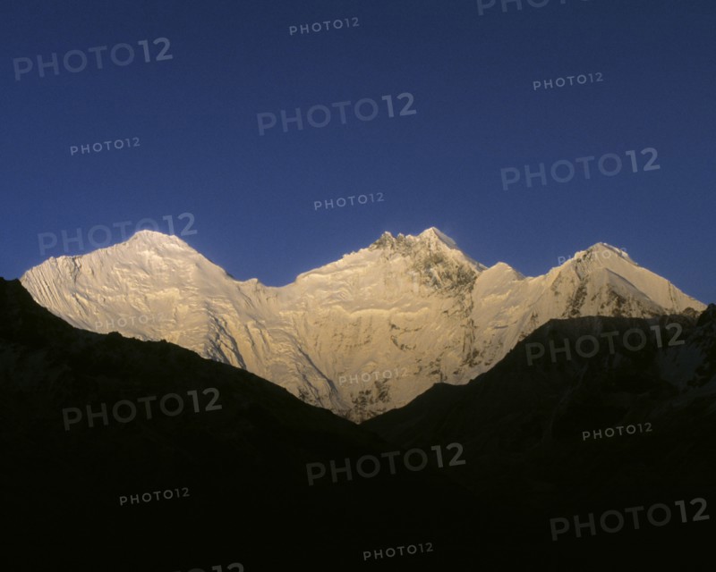 Snowy mountaintops under blue sky