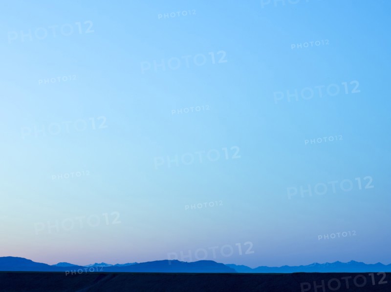 Silhouette of mountain range under blue sky