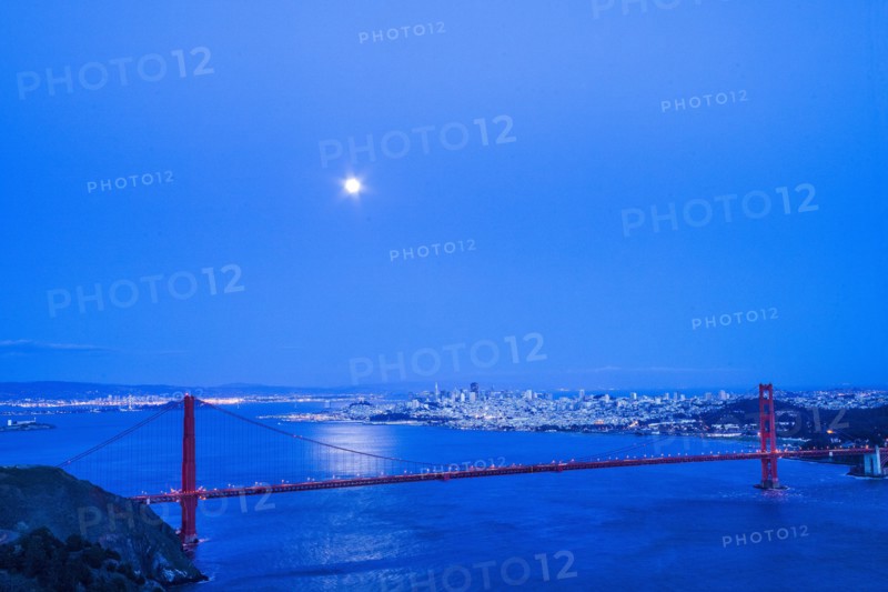 Moon in night sky over Golden Gate Bridge