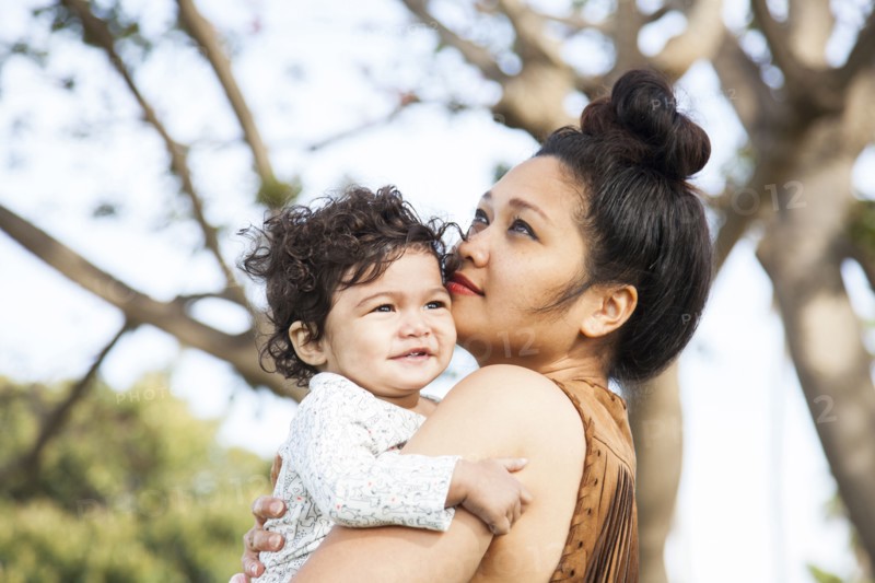 Mother holding baby son outdoors