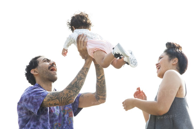 Parents playing with baby son outdoors