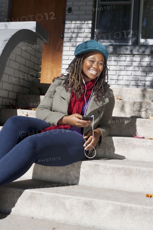 Black woman listening to music on mp3 player
