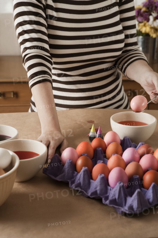 Woman dying Easter eggs