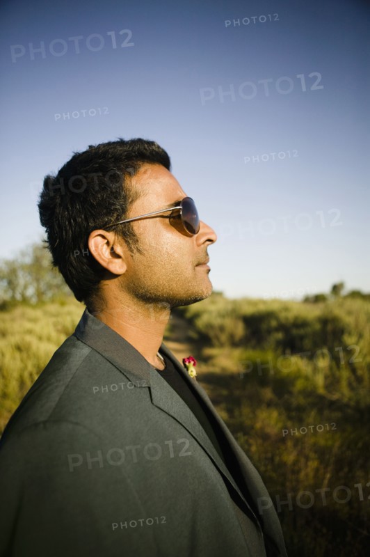Serious mixed race man in field