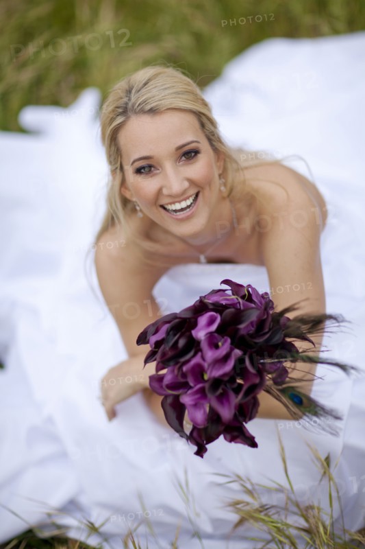 Hispanic bride holding bouquet of flowers