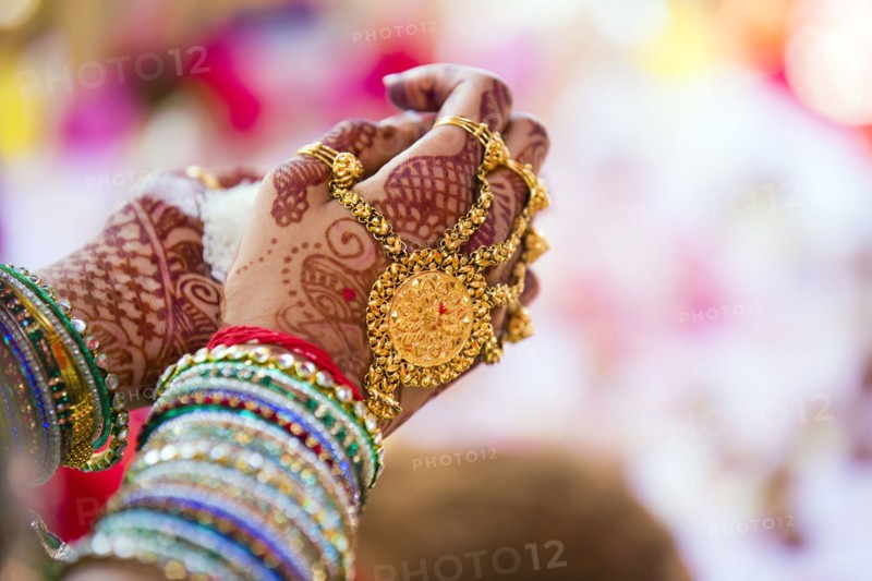 Close up of hands with intricate henna design