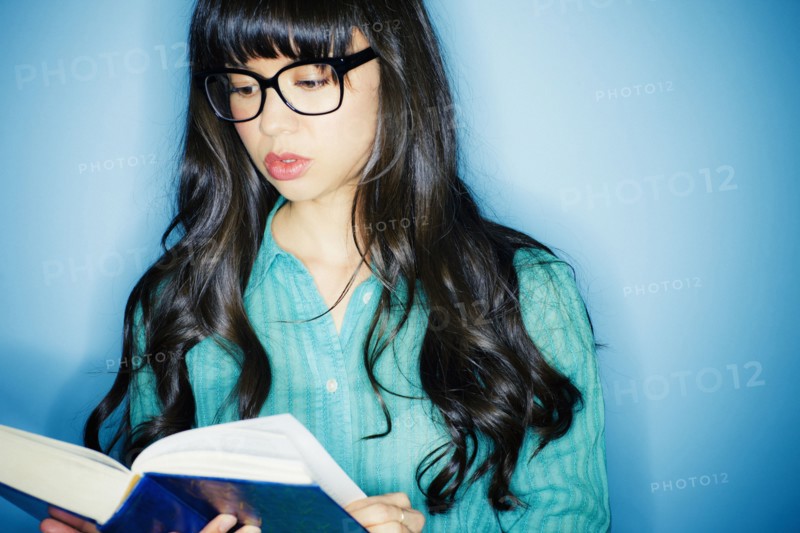 Mixed race woman reading book