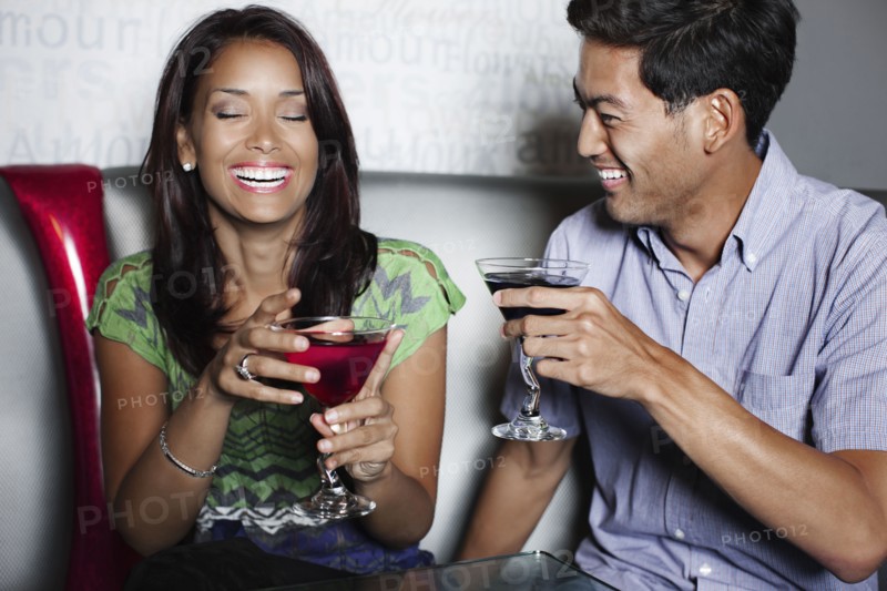 Couple drinking cocktails in nightclub