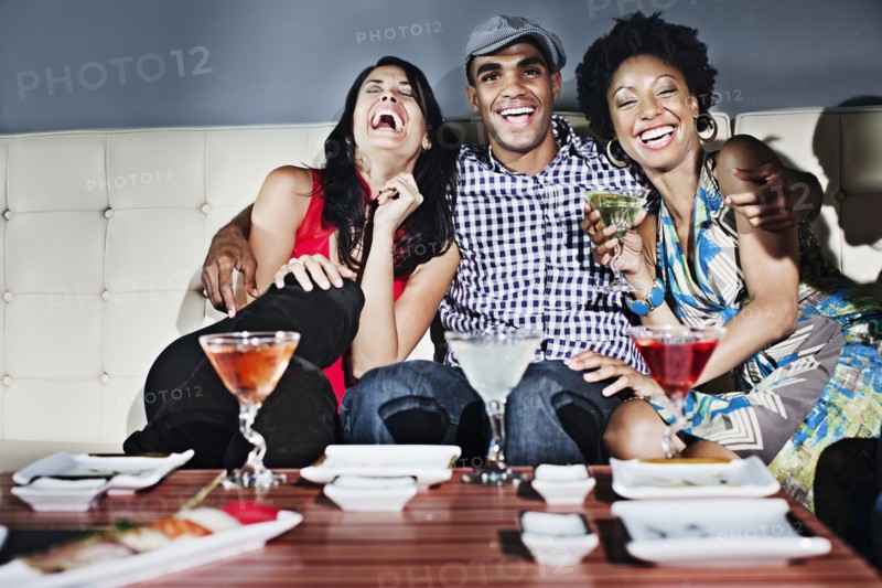 Friends drinking cocktails in nightclub