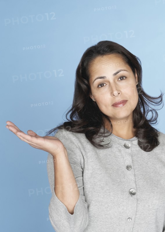 Skeptical Hispanic woman gesturing