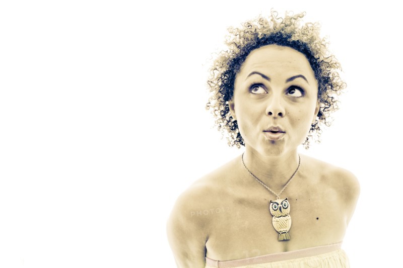 Portrait of curious woman wearing owl necklace