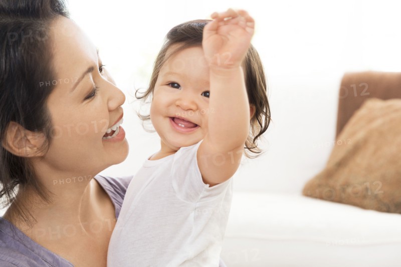 Mother playing with baby girl