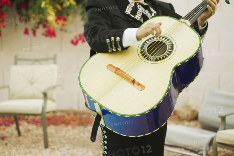 Mariachi band member holding guitar