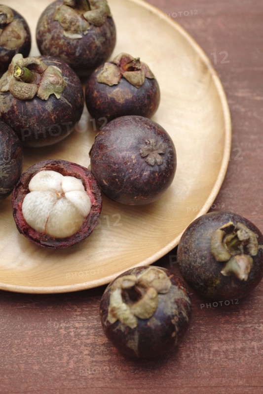 Mangosteen on wooden dish