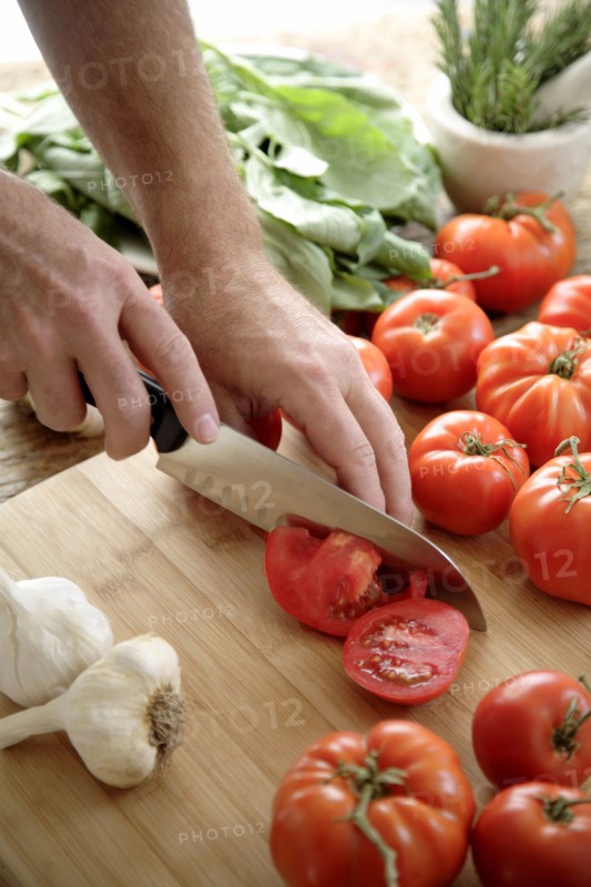 Caucasian man chopping tomatoes